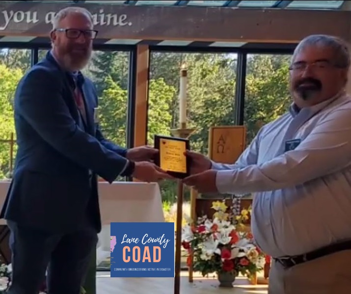 Thomas Price (right) was honored for his service during McKenzie Fire recovery efforts.