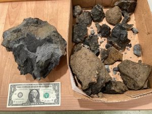 Sandra Bishop collected some of the rocks and blast debris that struck her home Tuesday during blasting for the two new EWEB water storage tanks.